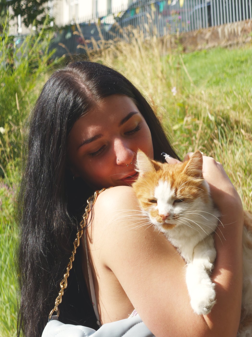 Emmy Bloom holding a ginger cat close
